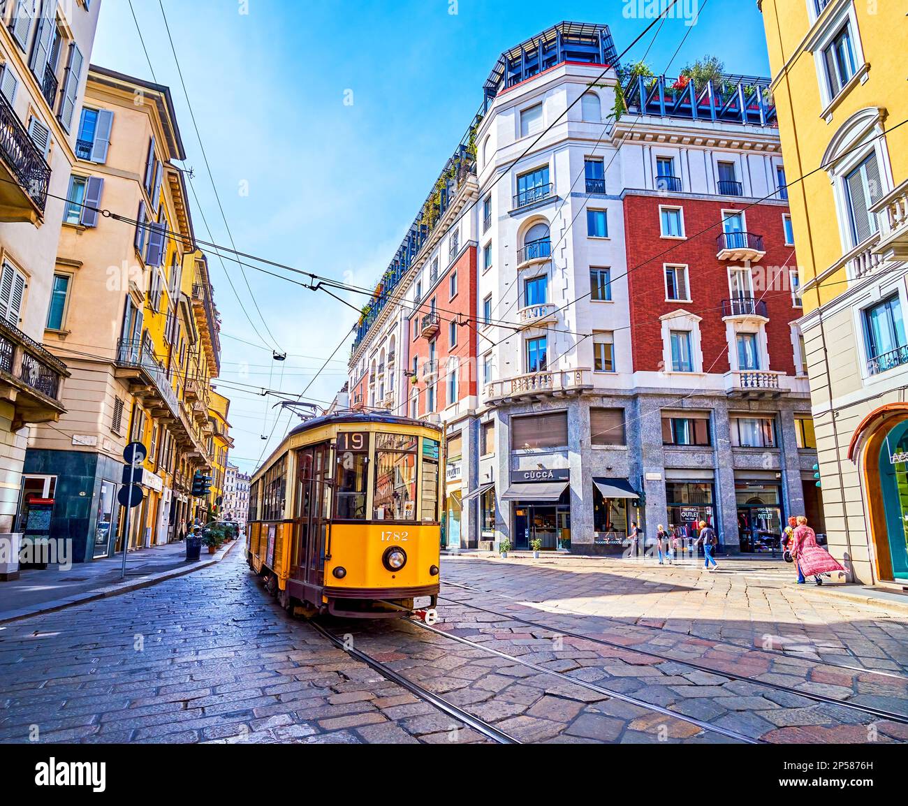 MILAN, ITALY - APRIL 11, 2022: Yellow retro tram rides along Corso Magenta street, on April 11 in Milan, Italy Stock Photo