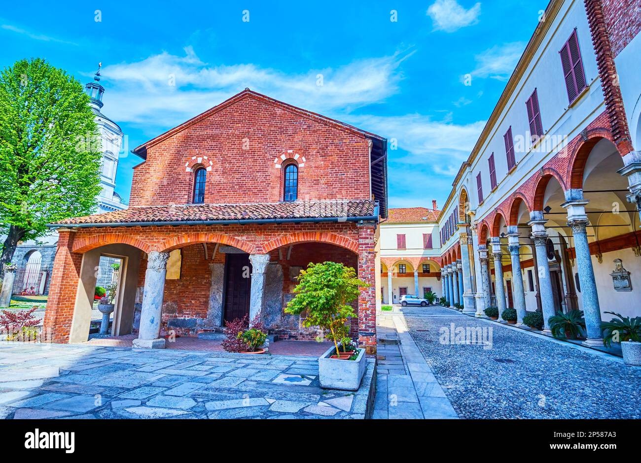 The courtyard of Basilica of Sant'Ambrogio with ancient buildings of the complex, Milan, Italy Stock Photo