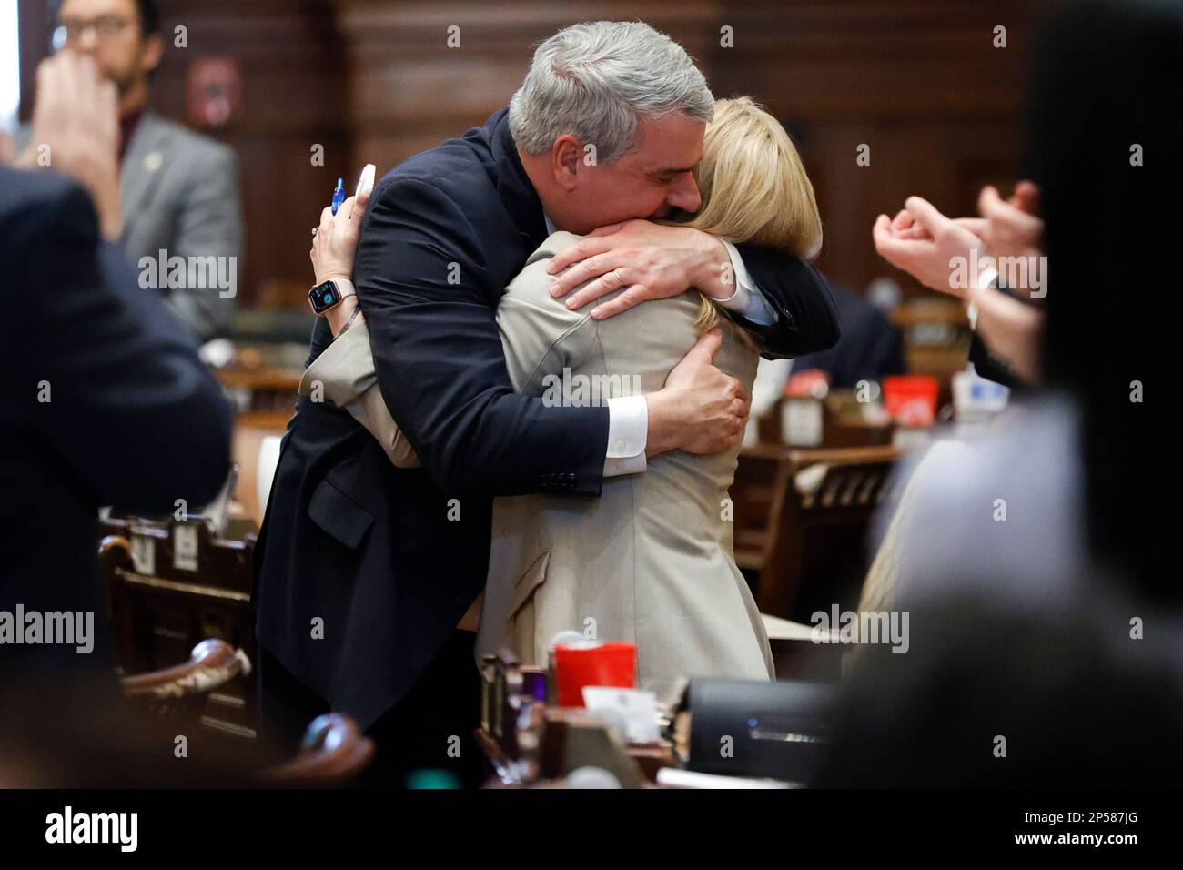 Rep. John Carson, R-Marietta, left, and Rep. Esther Panitch, D-Sandy  Springs, right, embrace in the House chambers after the passage of HB 30  during crossover day at the Georgia State Capitol on