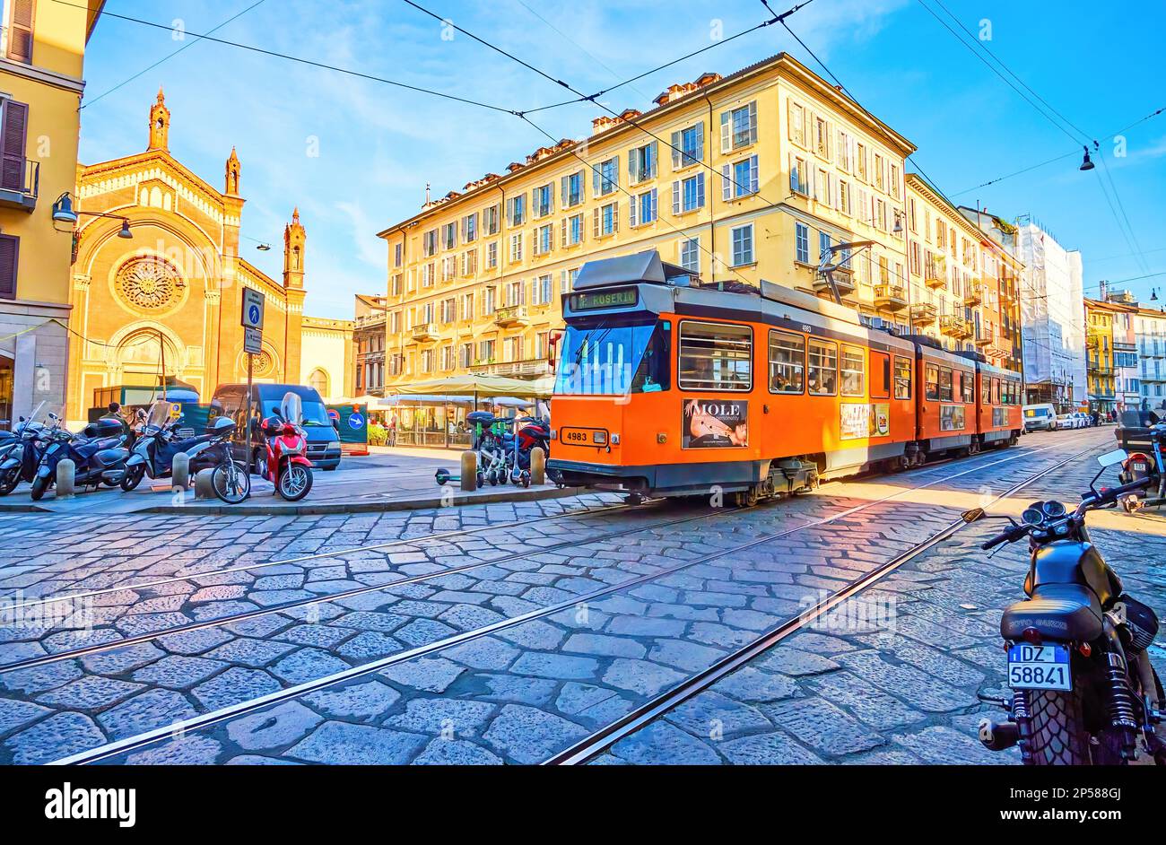 MILAN, ITALY - APRIL 11, 2022: Modern tram rides in Brera district, passing Piazza del Carmine, on April 11 in Milan, Italy Stock Photo