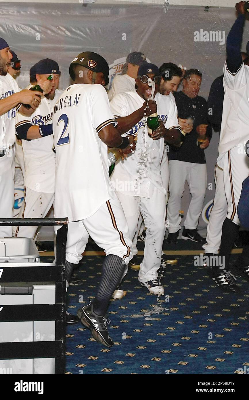 MILWAUKEE, WI - SEPTEMBER 23: Nyjer Morgan #2 of the Milwaukee Brewers  celebrates the division tittle in the locker room with Yuniesky Betancourt  #3 after the game against the Florida Marlins at