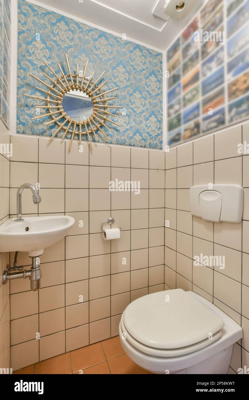 a bathroom with blue and white wallpapers on the walls, including a