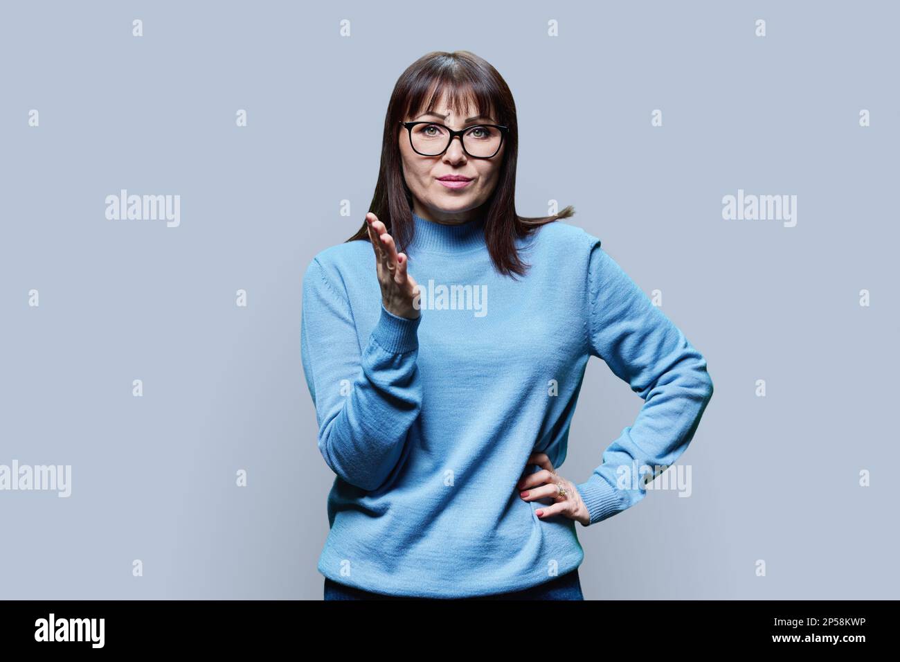 Mature woman gray hair gesturing hi-res stock photography and images ...
