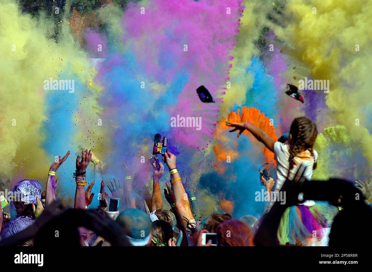 Participants in the Color Run celebrate and release their color packets at Adado Riverfront Park