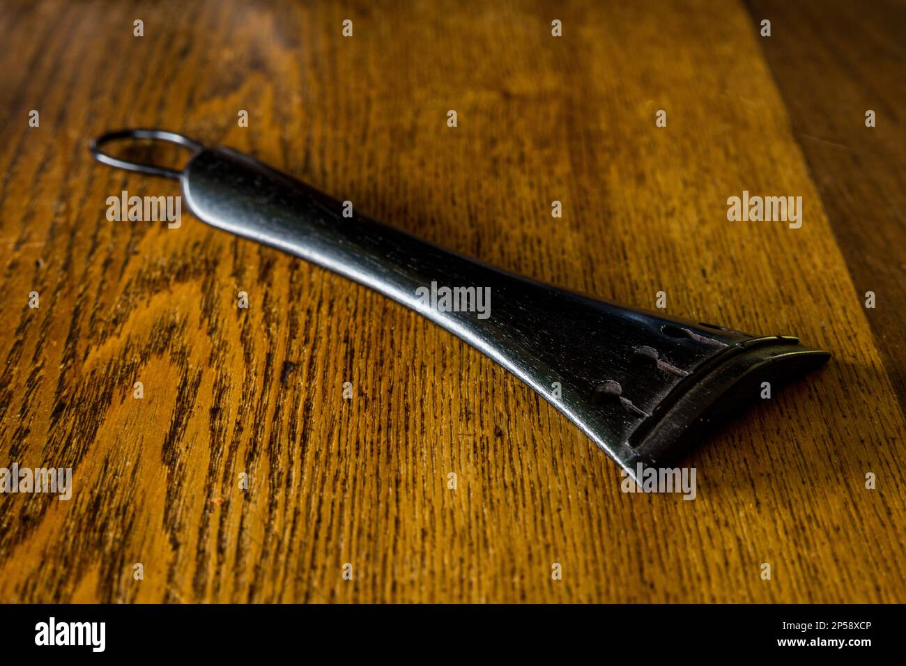 A 100 year old ebony Viola tailpiece Stock Photo