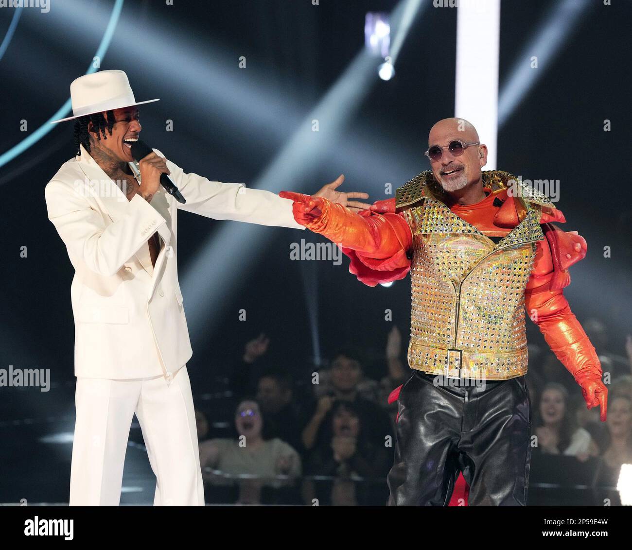 THE MASKED SINGER, from left: host Nick Cannon, Howie Mandel as Rock