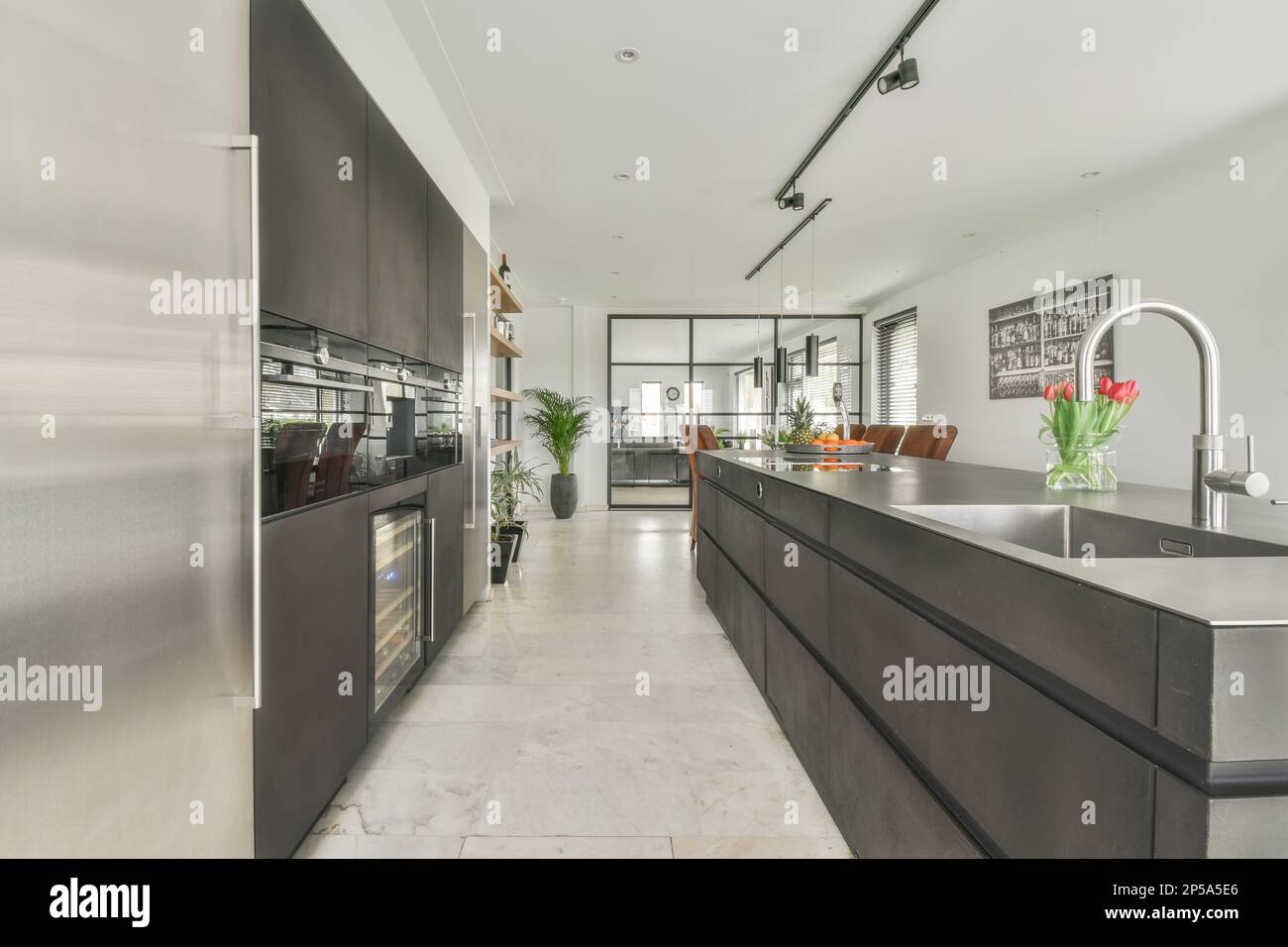 a modern kitchen with stainless steel appliances in the center and an ...