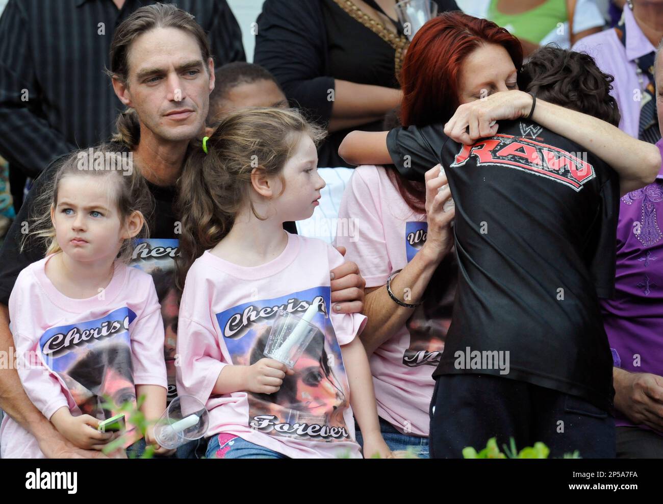 Rayne Perrywinkle (right) gets a hug during a service for her daughter