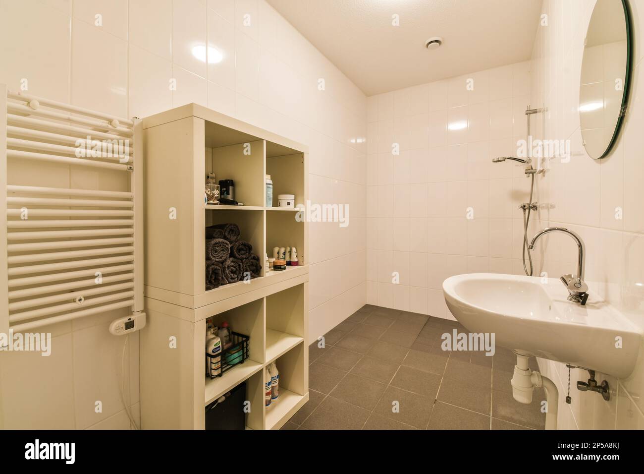 Amsterdam, Netherlands 10 April, 2021 a bathroom with a sink and towel rack next to the