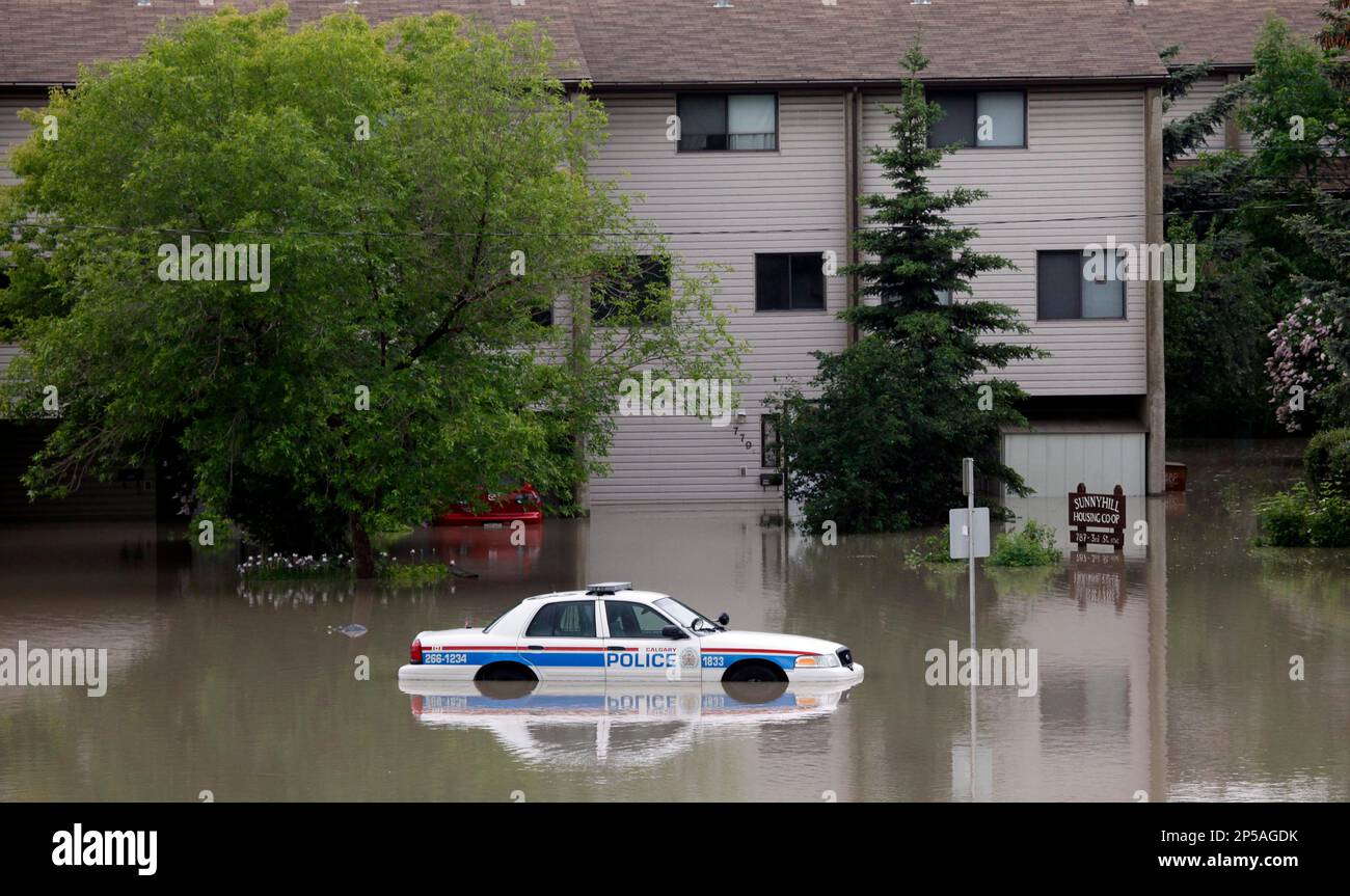 A Police Car Sits Stuck In A Parking Lot Of An Apartment Building After   A Police Car Sits Stuck In A Parking Lot Of An Apartment Building After Heavy Rains Have Caused Flooding Closed Roads And Forced Evacuation In Calgary Alberta Canada Friday June 21 2013 Ap Photothe Canadian Press Jeff Mcintosh 2P5AGDK 