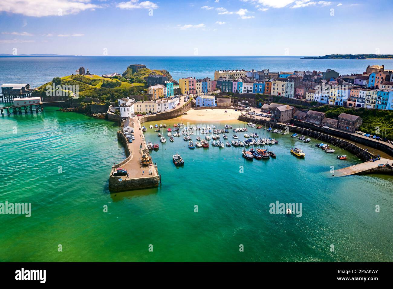 Aerial view of colourful buildings around a small harbour (Tenby, Wales