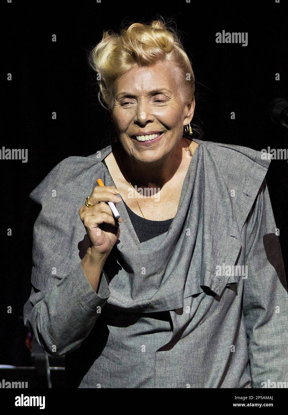 Joni Mitchell smokes an electronic cigarette on stage during her 70th  birthday tribute concert as part of the Luminato Festival at Massey Hall in  Toronto on Tuesday June 18, 2013. (AP Photo/The