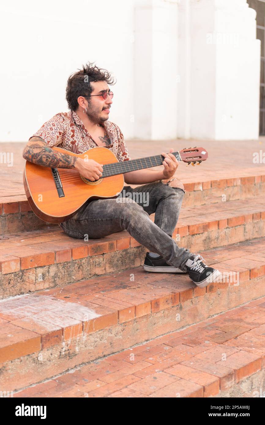 Street singer playing his guitar in Colombia Stock Photo - Alamy