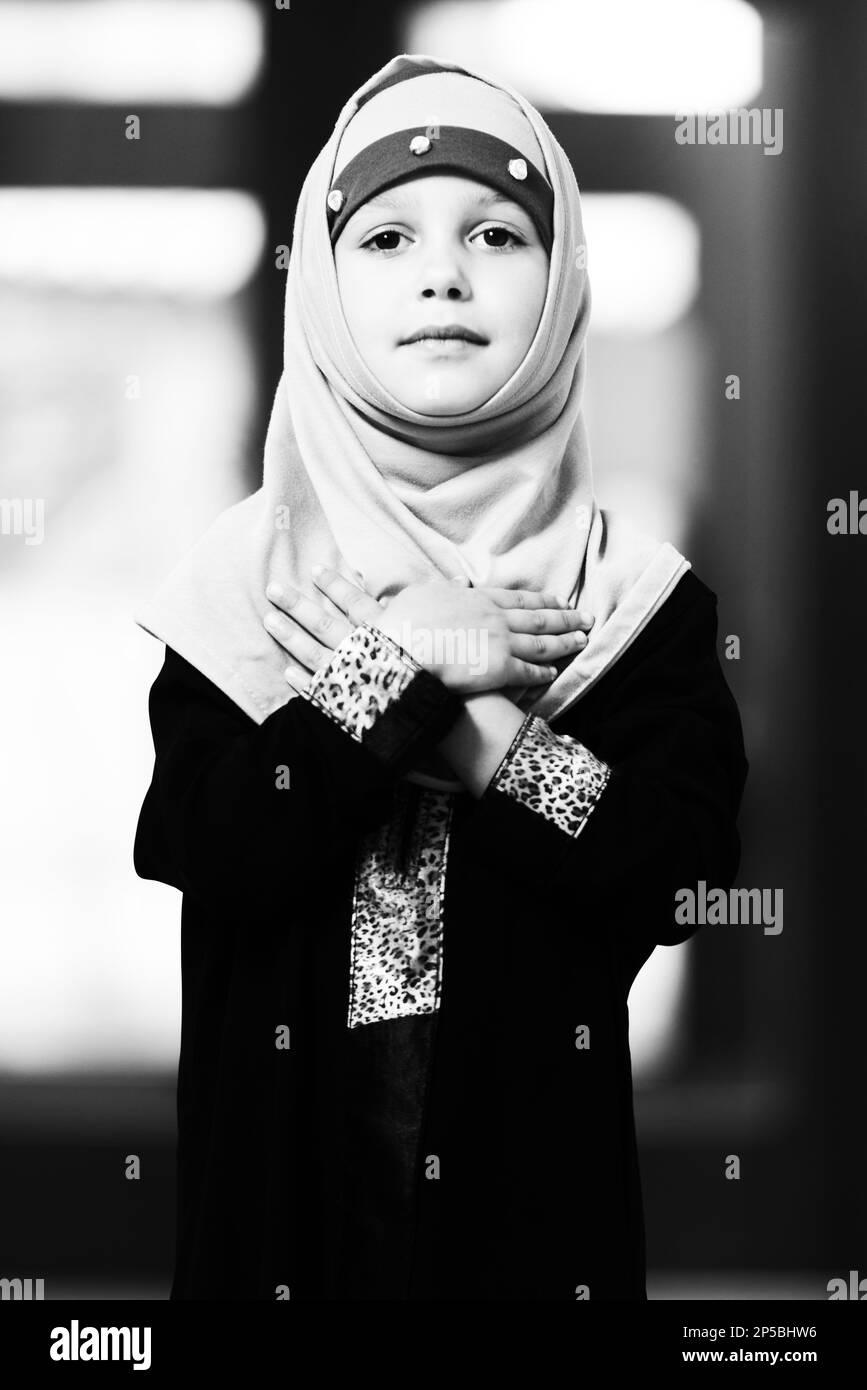 Young Muslim Girl Making Traditional Prayer To God While Wearing A