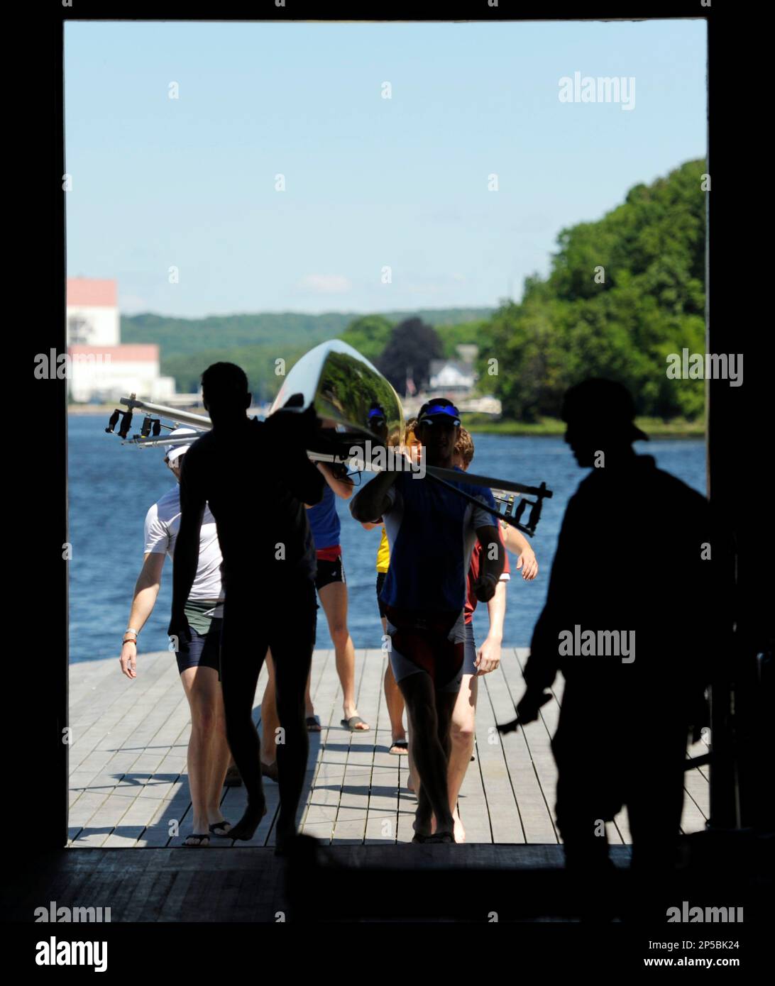 Harvard University's 1st varsity men's crew team carry their rowing