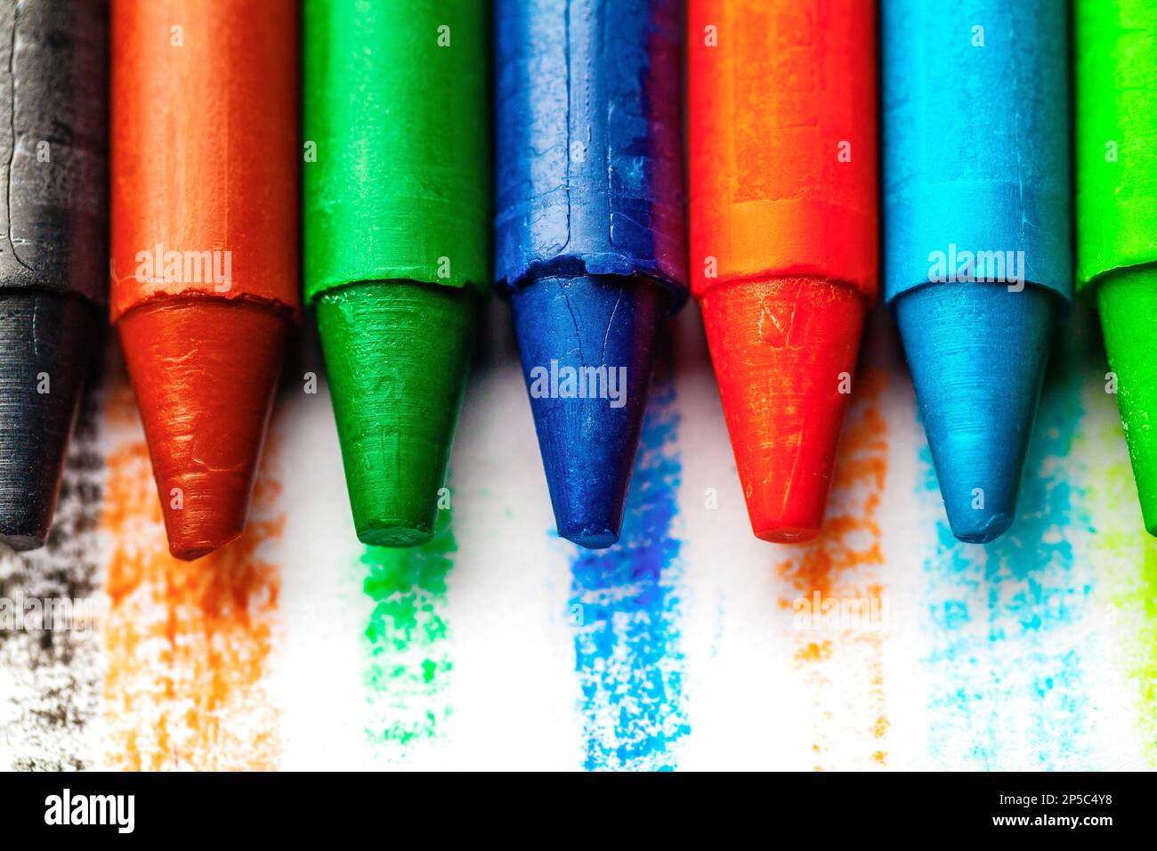 Several colors of wax crayons of different shades. Used for painting or