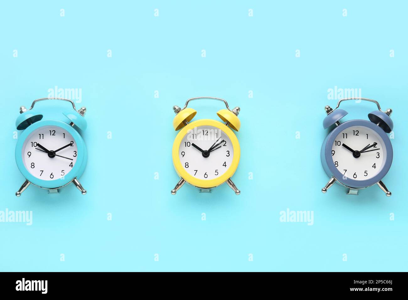 Alarm clocks on blue background Stock Photo