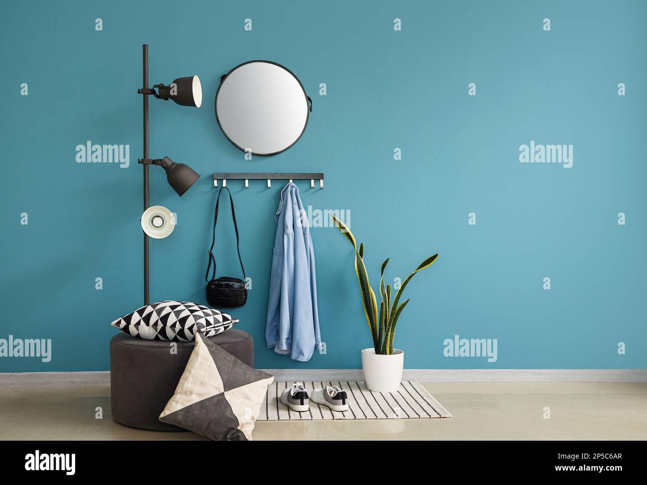 Interior of stylish hall with rack, mirror and lamp Stock Photo - Alamy