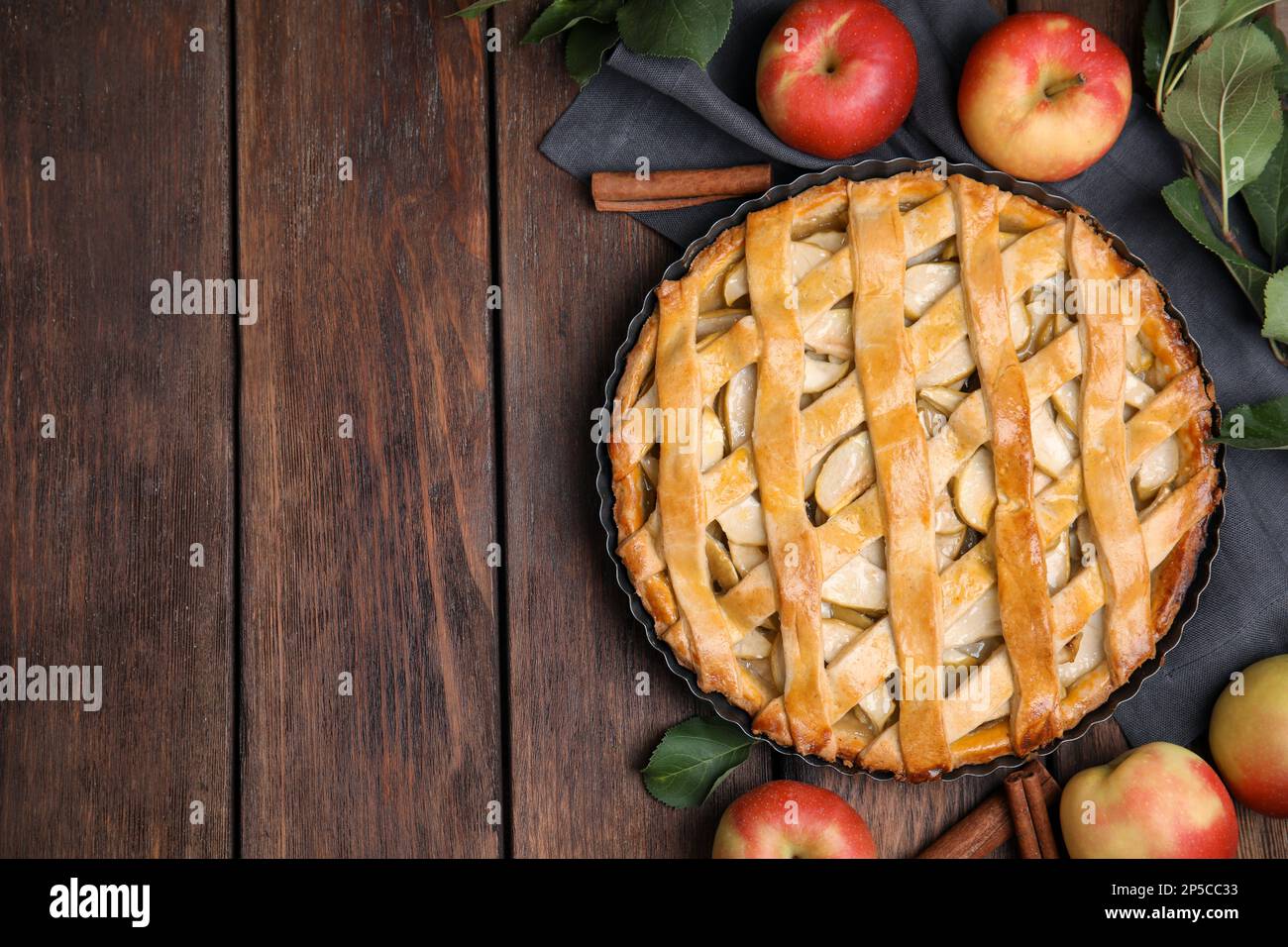 Delicious traditional apple pie on wooden table, flat lay. Space for text Stock Photo