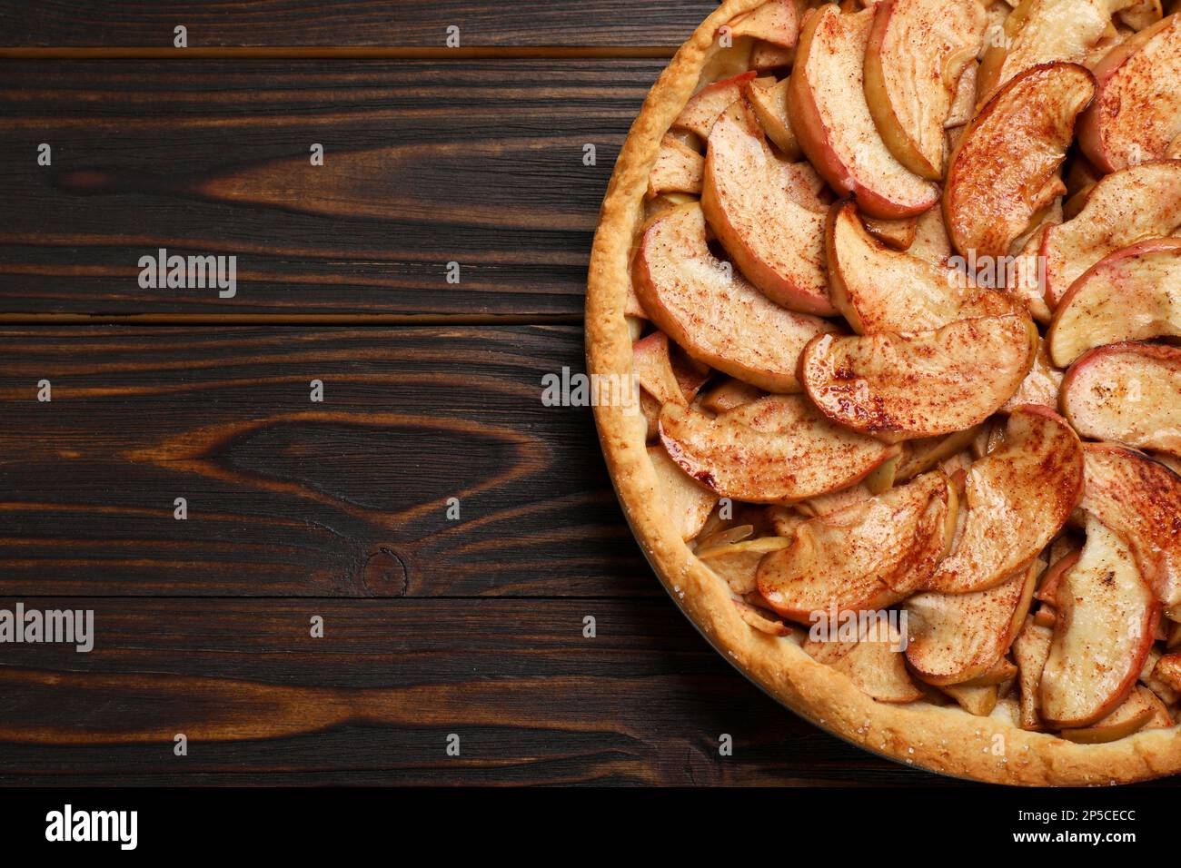 Delicious apple pie on wooden table, top view. Space for text Stock Photo