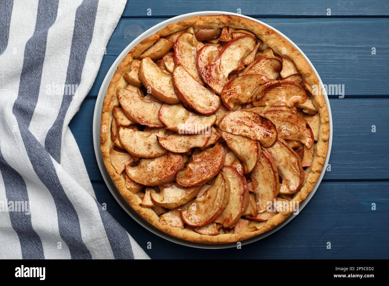 Delicious apple pie on blue wooden table, top view Stock Photo