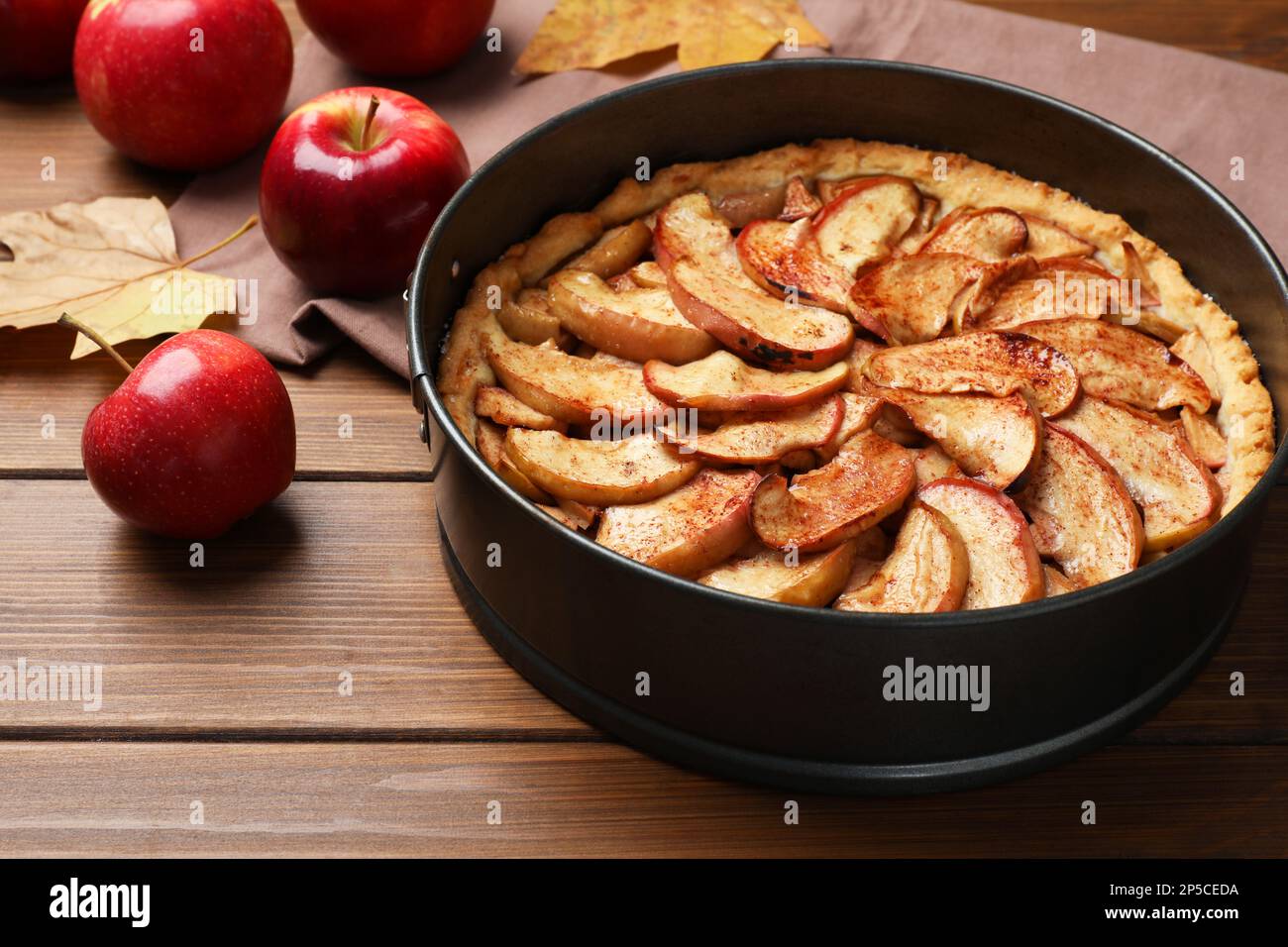 Delicious apple pie and fresh fruits on wooden table Stock Photo