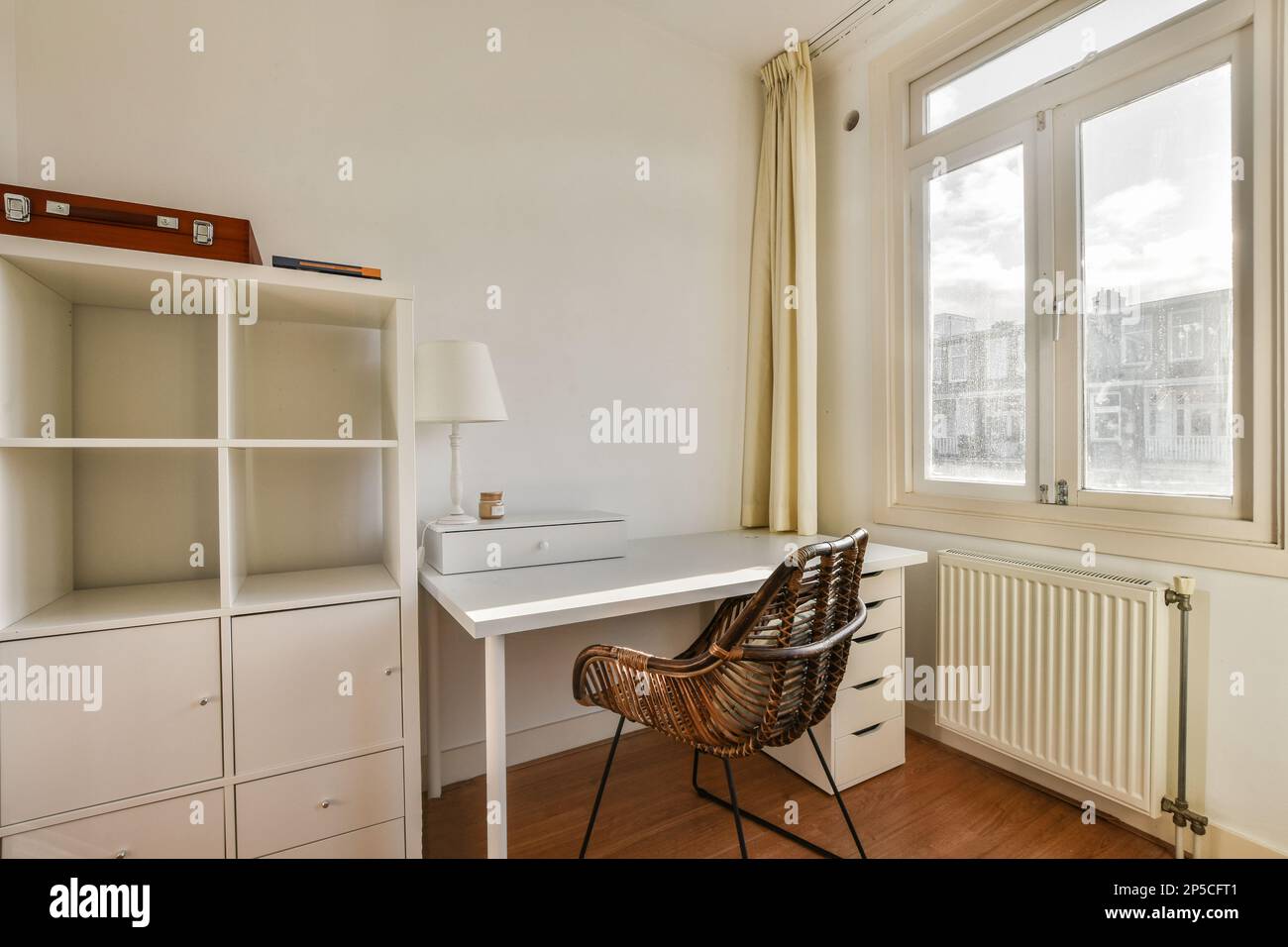 a small room with a desk and chair in front of a window that looks out ...