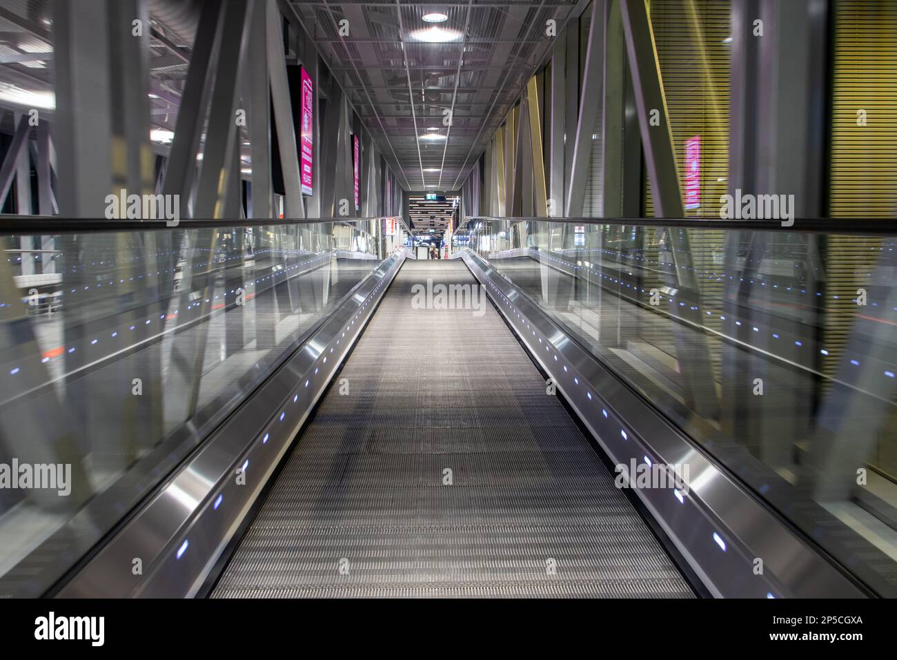 A ride on moving walkway inside a tunnel Stock Photo