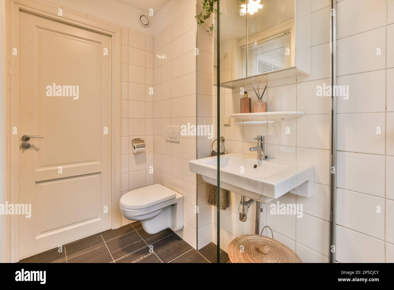 a bathroom with a toilet, sink and mirror on the wall next to the