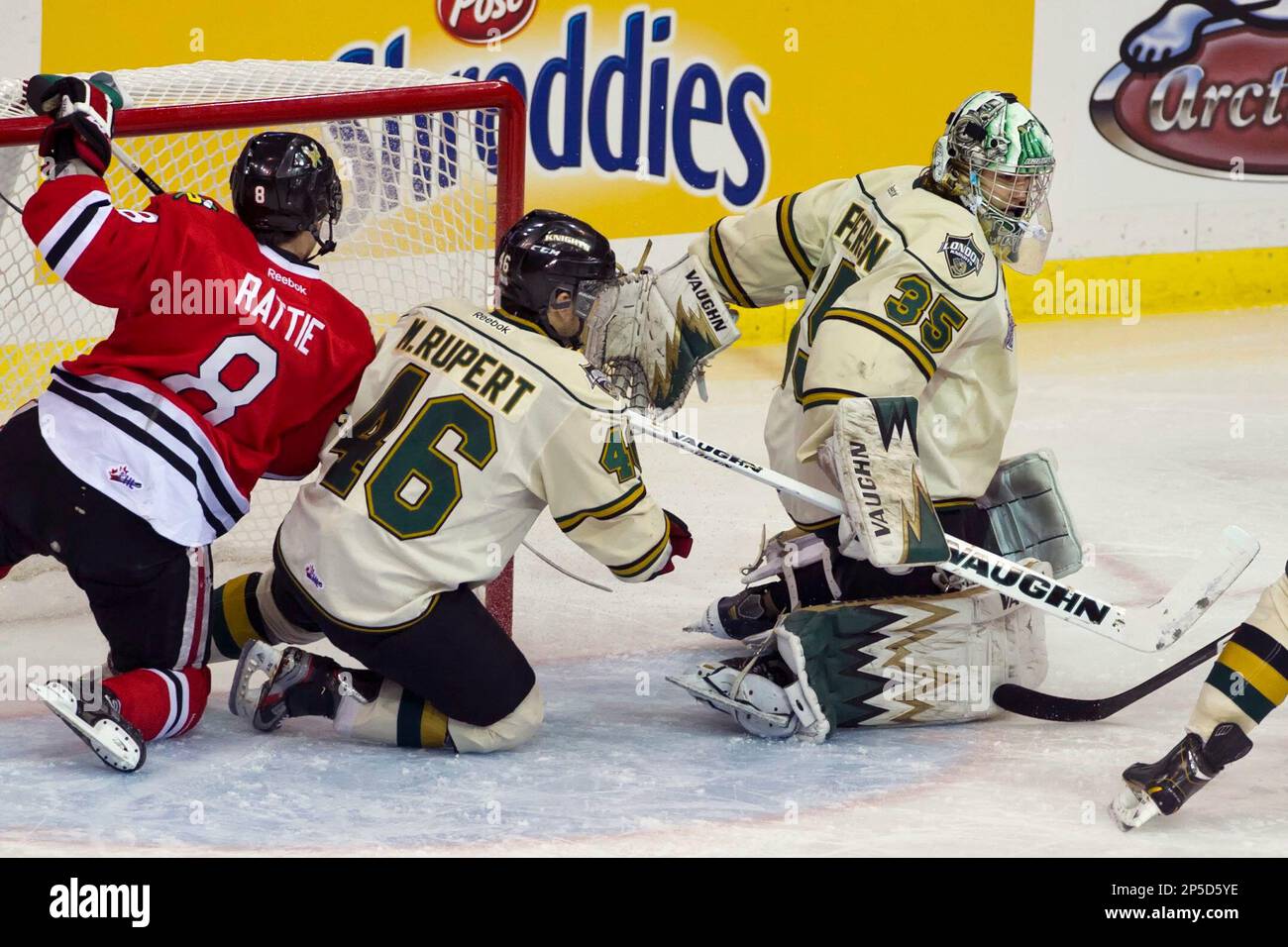 Portland Winterhawks right winger Ty Rattie and London Knights left winger Matt Rupert run into the net behind goaltender Jake Patterson during the second period of Memorial Cup semifinal hockey game action