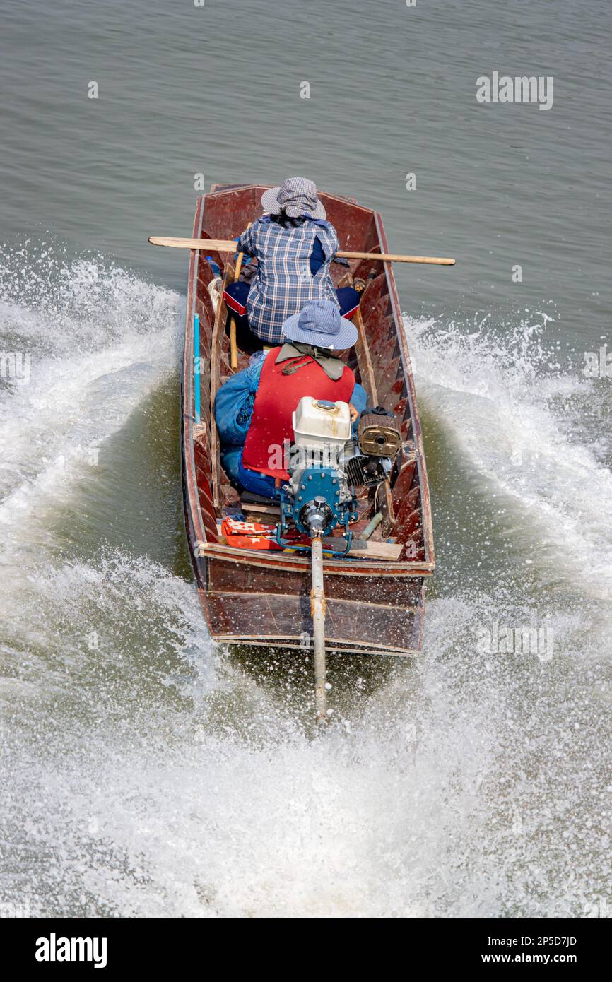 Fishermen sail on a boat with fishing nets, Thailand Stock Photo