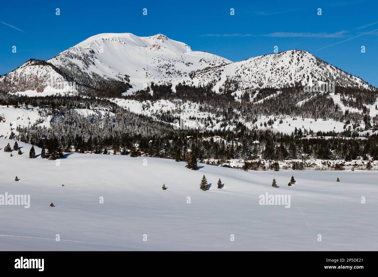 A view of snow-covered Mammoth Mountain ski resort with blue skies after a record snowfall. Stock Photo