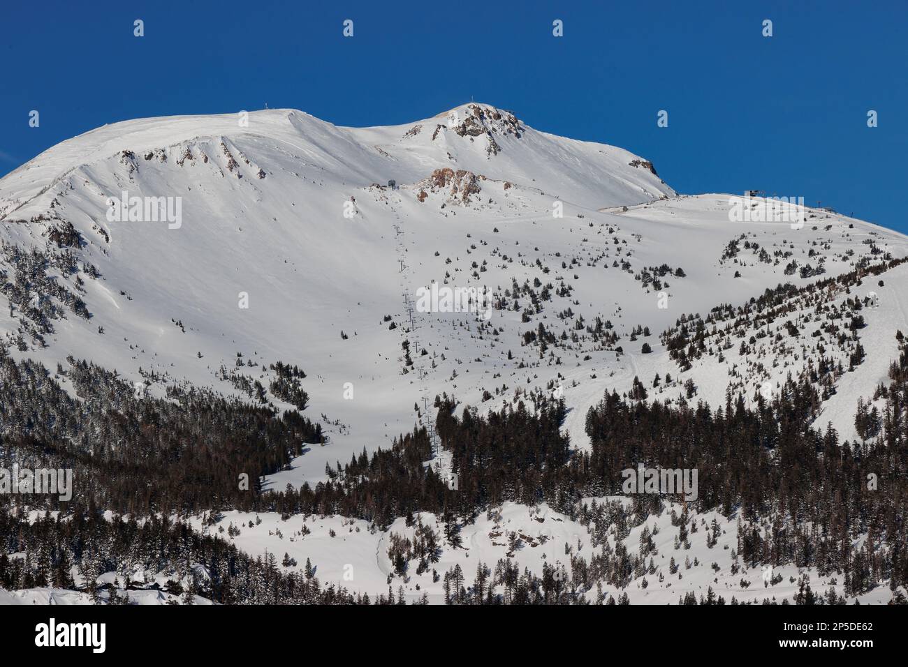 A view of snowcovered Mammoth Mountain ski resort with blue skies after a record snowfall Stock