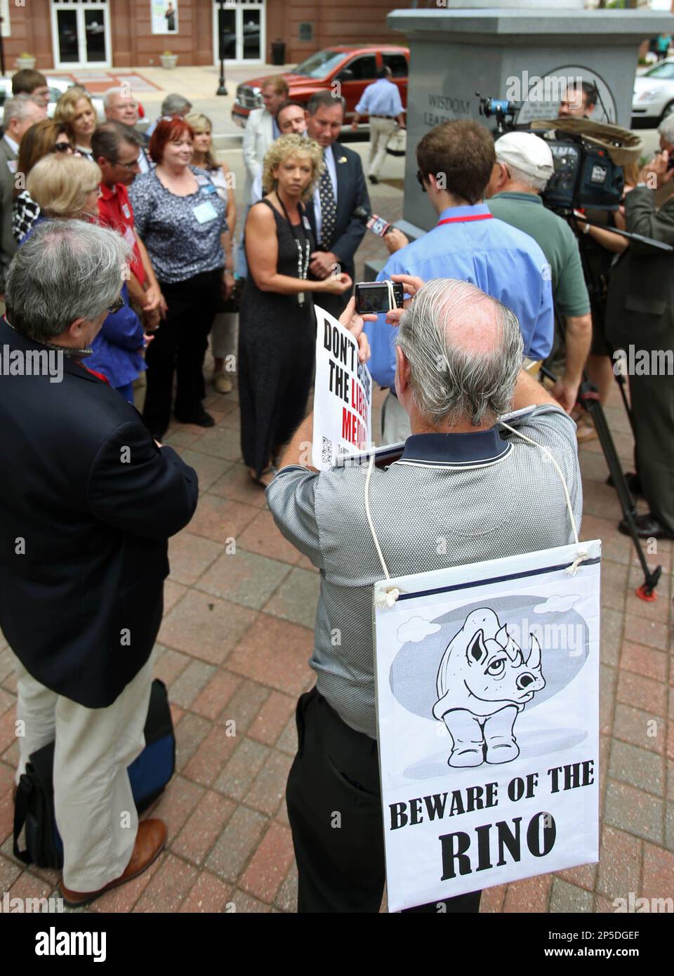 Conrad Quagliaroli, of Woodstock, wears a sign reading, 