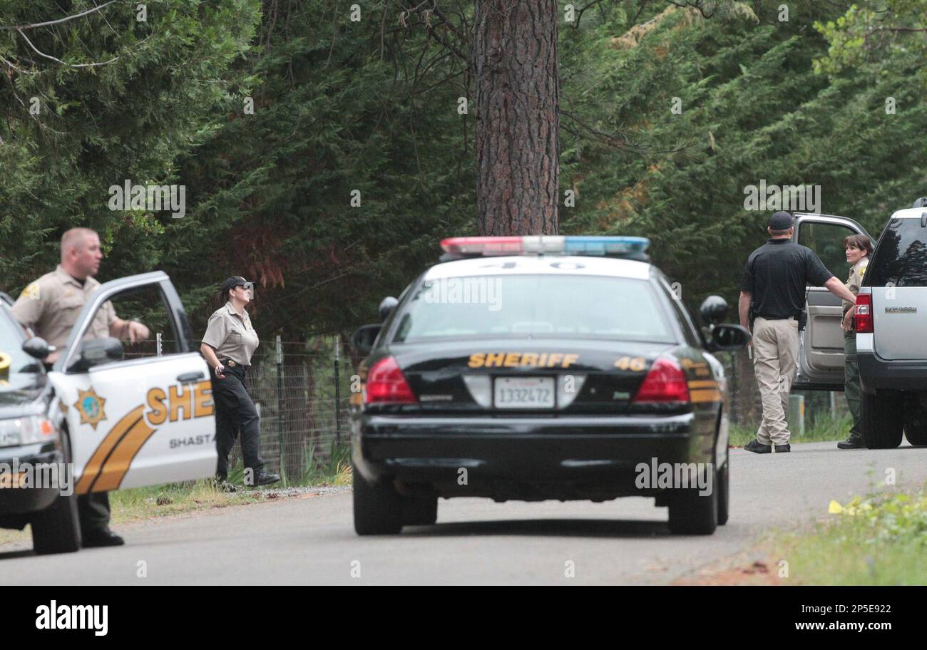 Shasta County Sheriff's deputies investigate the scene of a triple