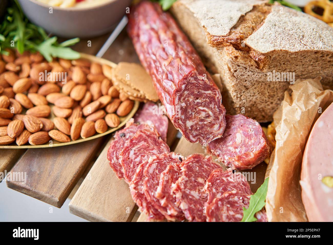 Salami sausage close-up. Table full of mediterranean appetizers, tapas ...