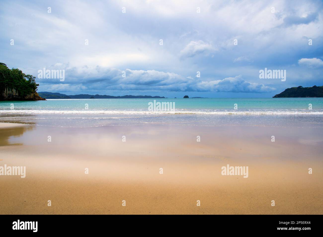 The beautiful golden sandy beach and clear blue water in the ocean in