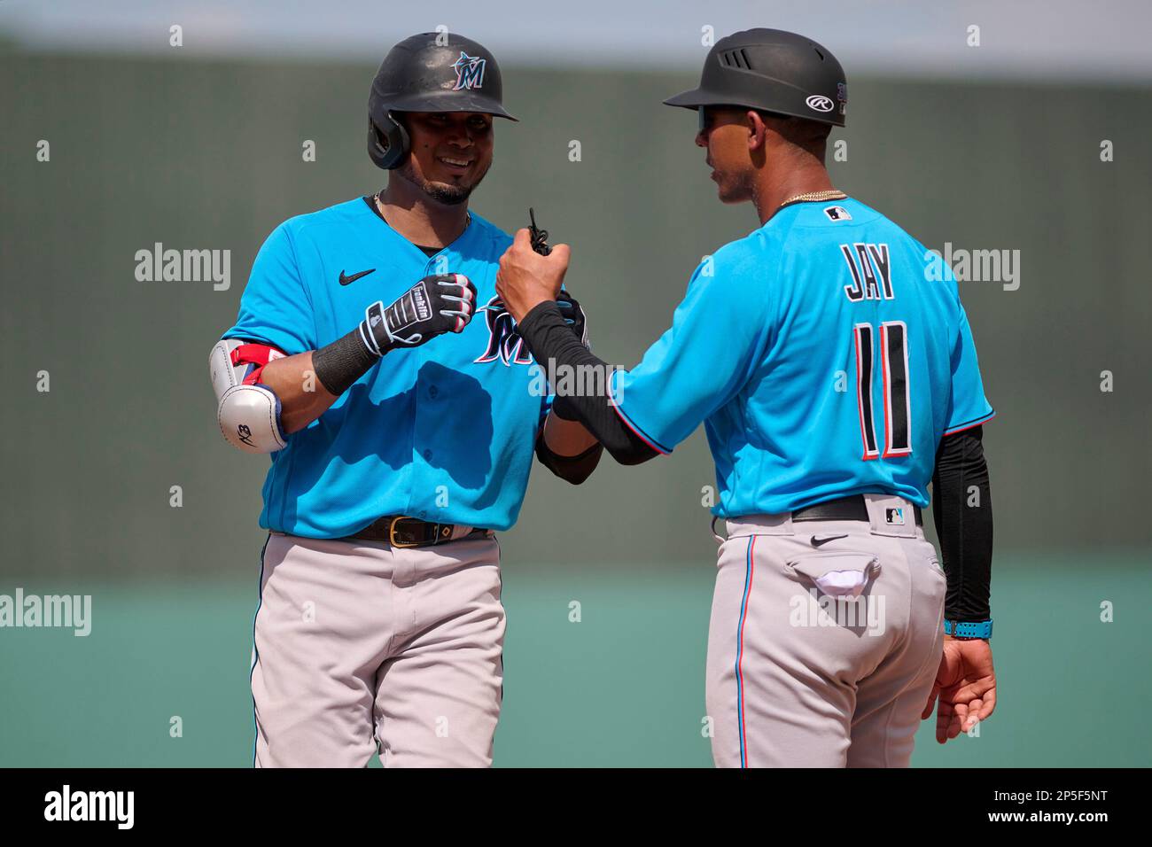 Miami Marlins Luis Arraez (3) with first base coach Jon Jay (11) during a  spring training baseball game against the Boston Red Sox on March 5, 2023  at JetBlue Park in Fort