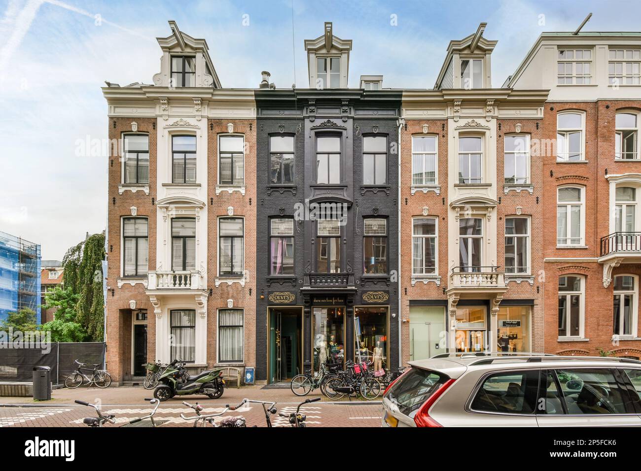 an apartment building with bicycles parked on the street next to it and ...