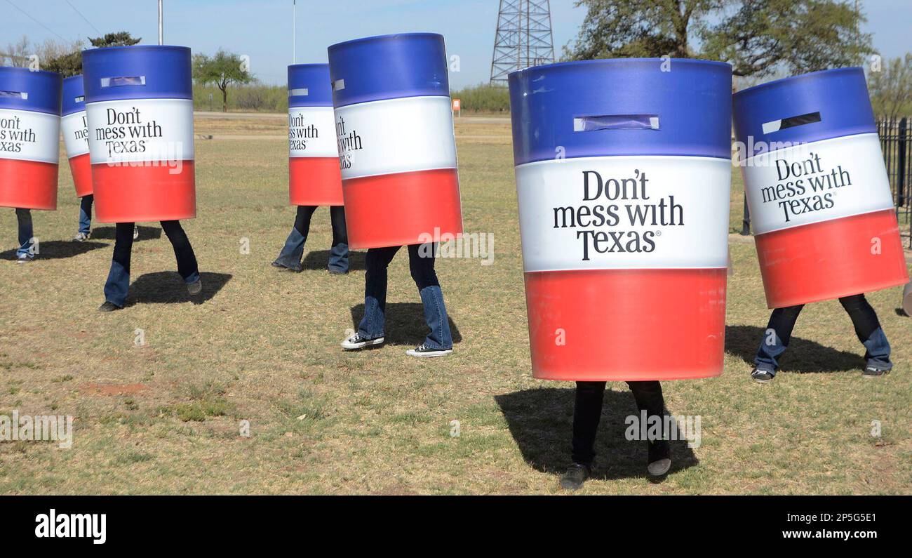 Members of the Odessa College Cheer Team dress as trash cans and dance