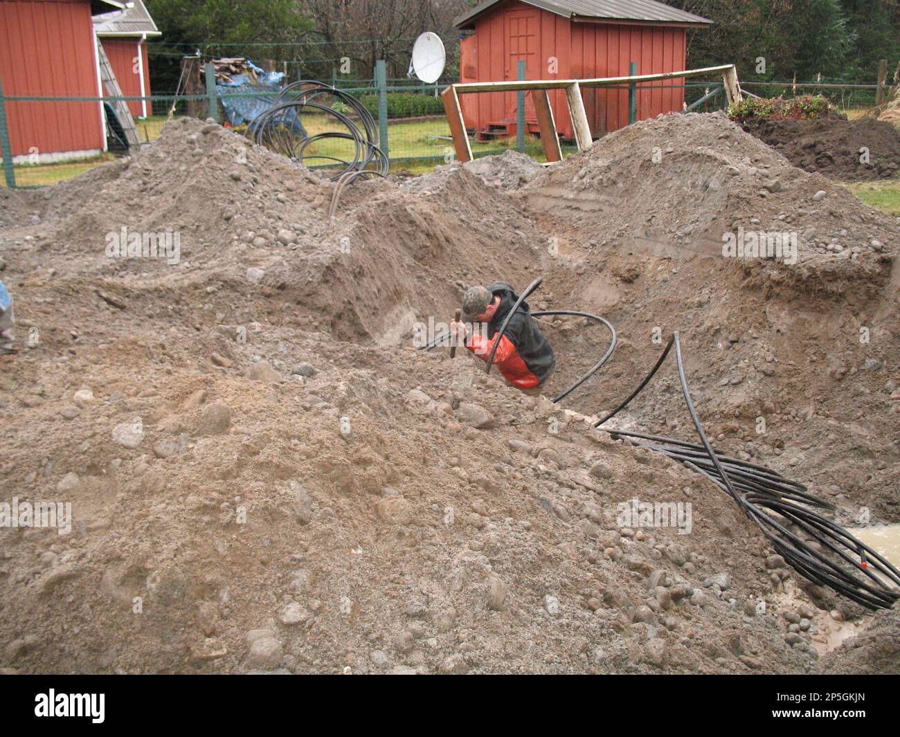 Contractors install the ground tubing of the geothermal heating system