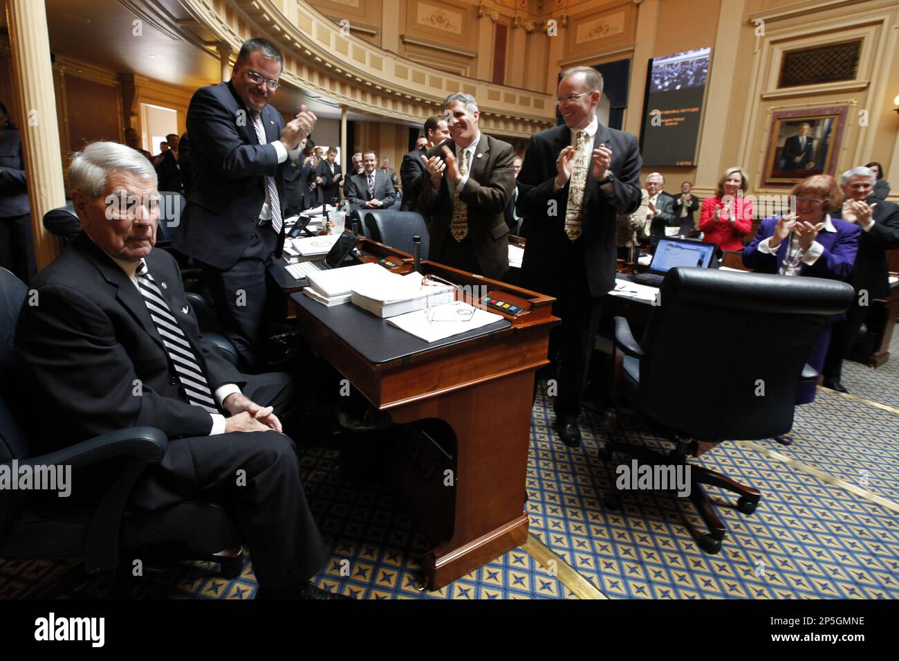 Retiring Del. Lacey E. Putney, IBedford, left, gets a standing ovation