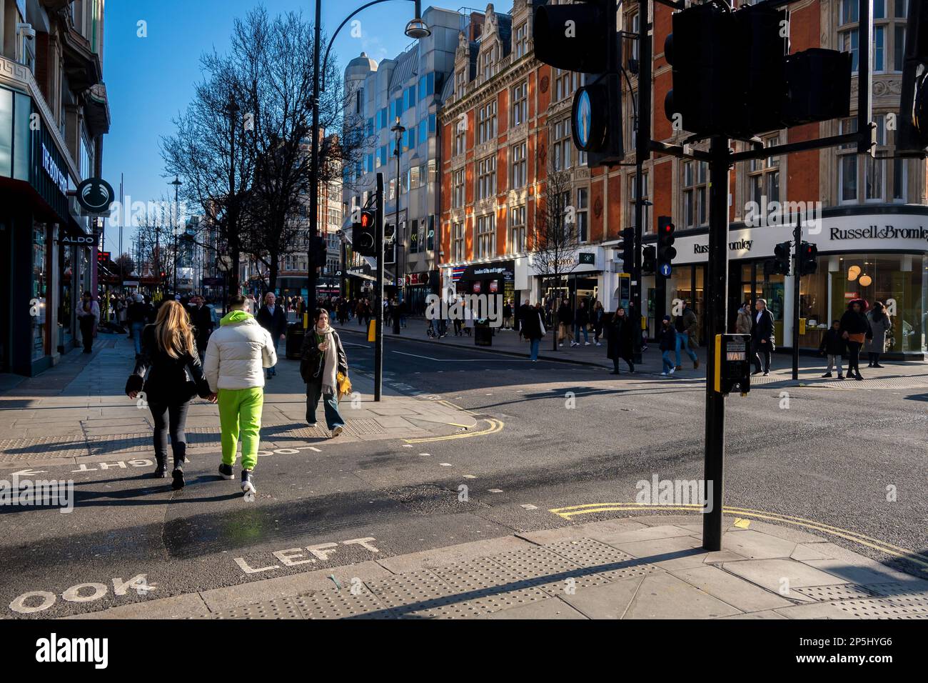 Oxford Street is a major road in the West End of London. walking people shops  and traffic early morning on road. Stock Photo