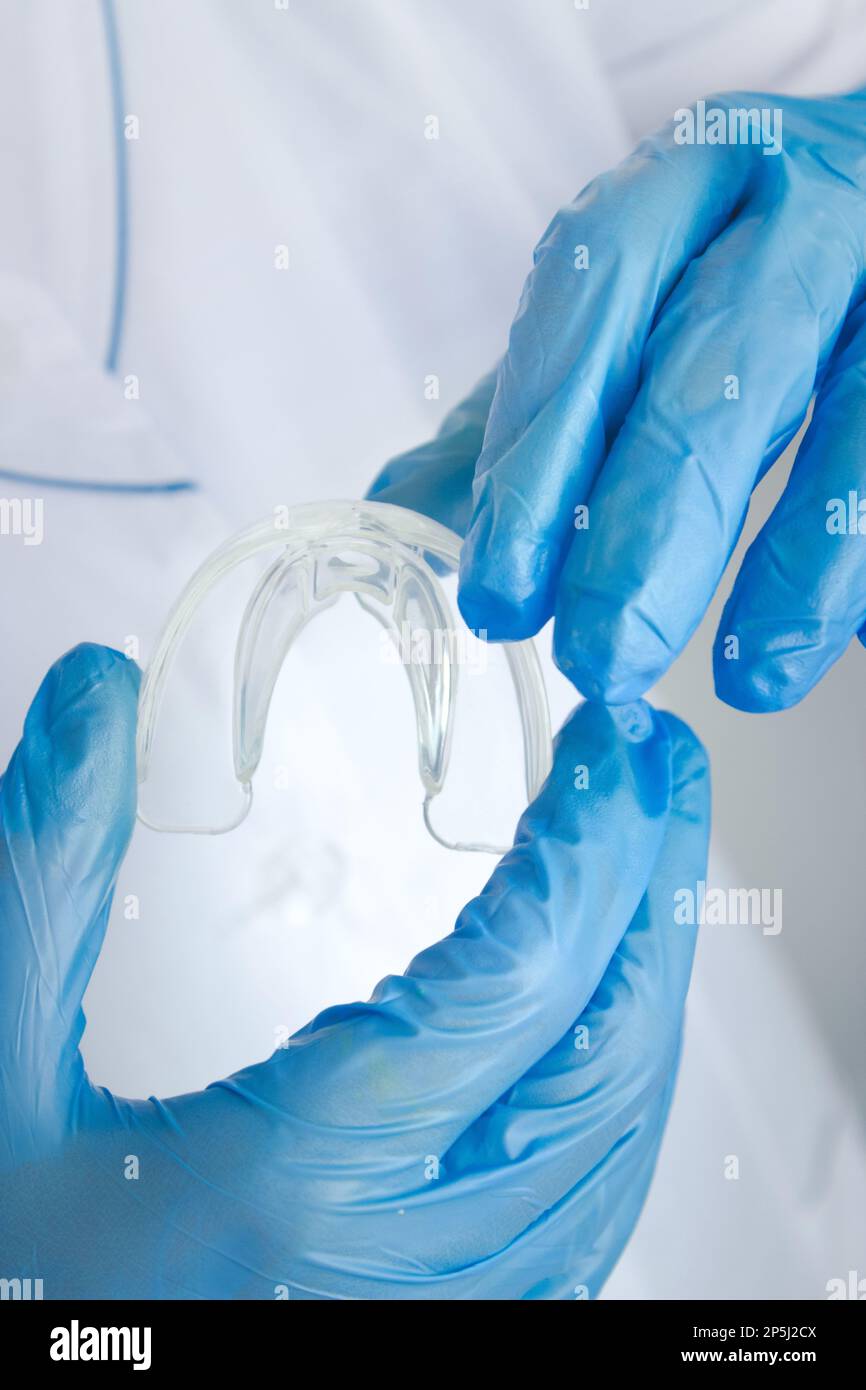 Teeth Whitening Tooth Tray in doctors hand, Closeup. Invisible