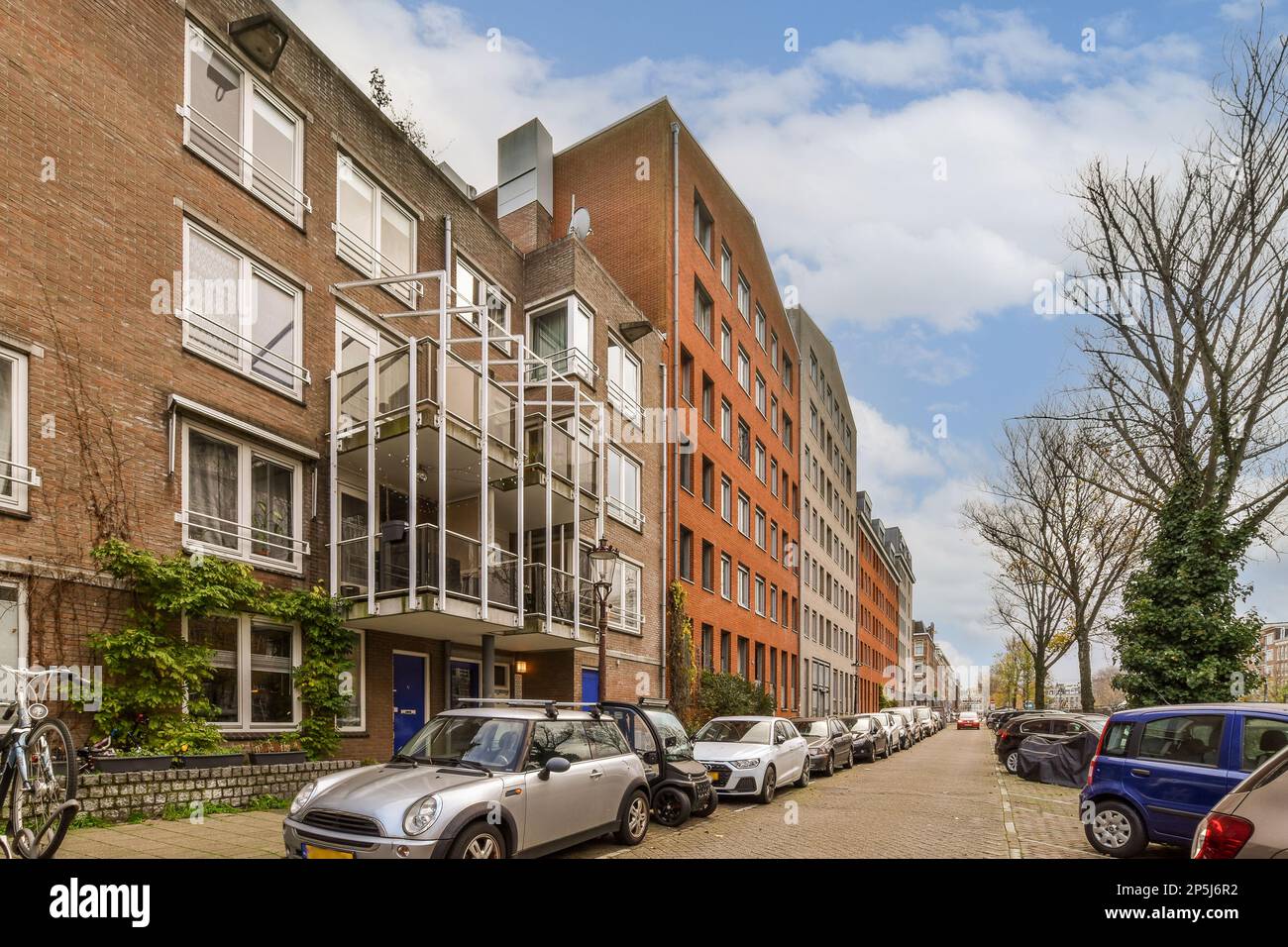 some cars parked on the side of a street in front of buildings with ...