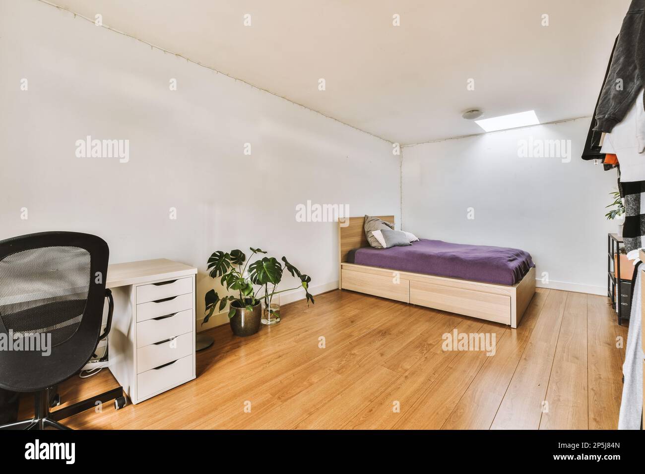 a bedroom with a bed, desk and computer on the floor next to an office ...