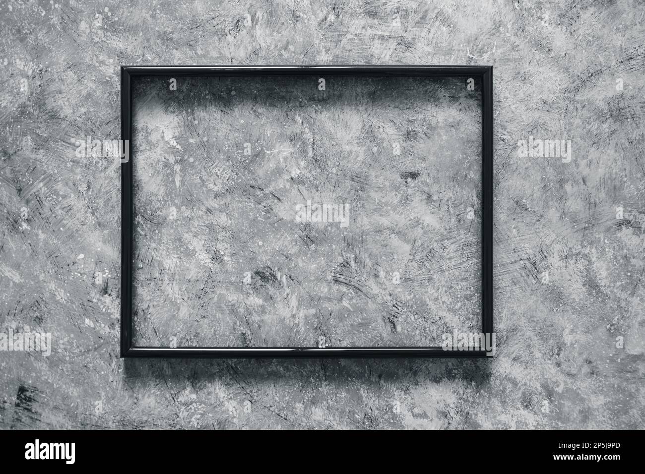 black rectangular picture frame mock-up with copy space for yout text or image on top of hand painted background in grey concrete style Stock Photo