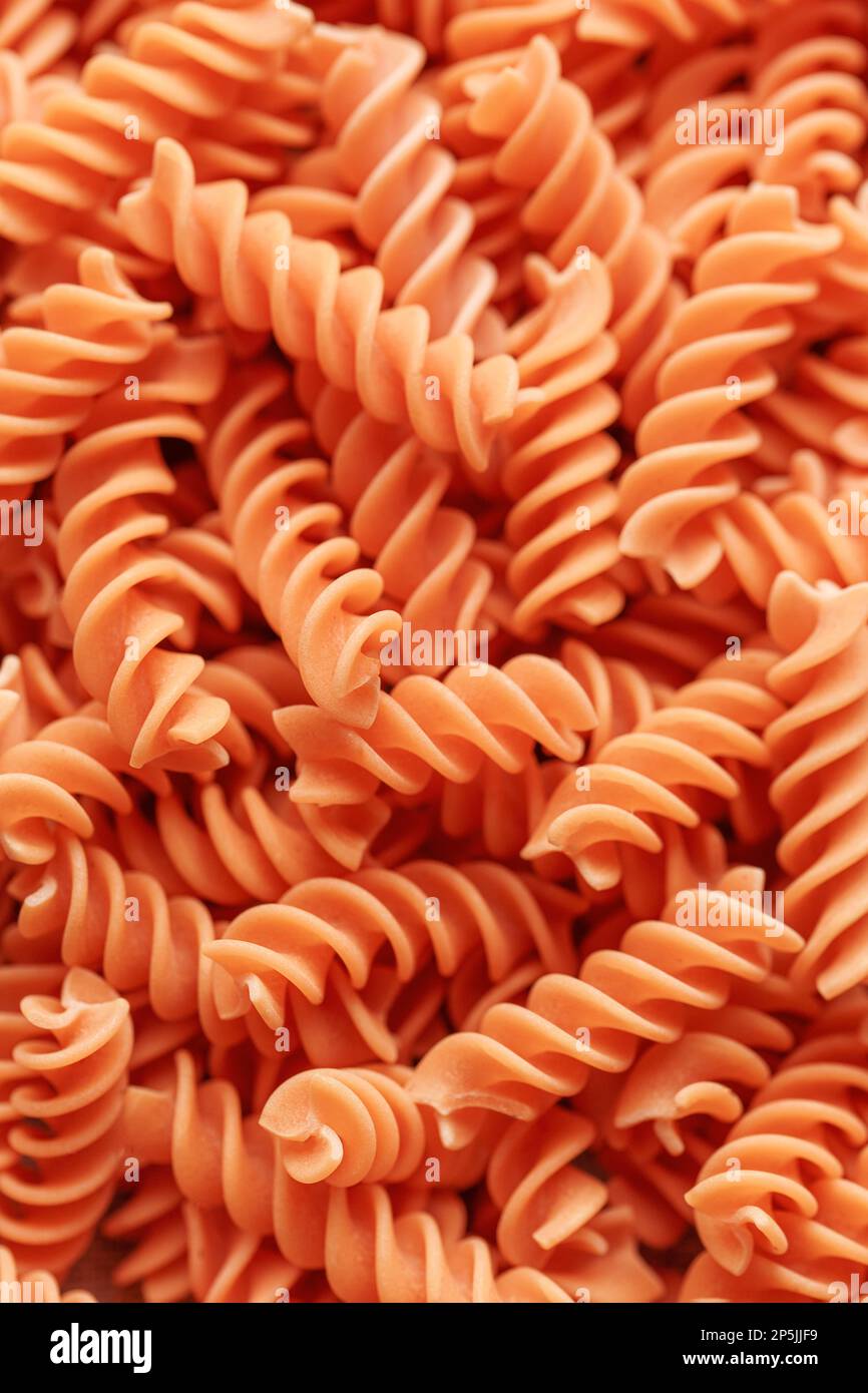 Pasta from red lentils. Gluten-free fusilli pasta. Alternative healthy food.  Food background. Stock Photo