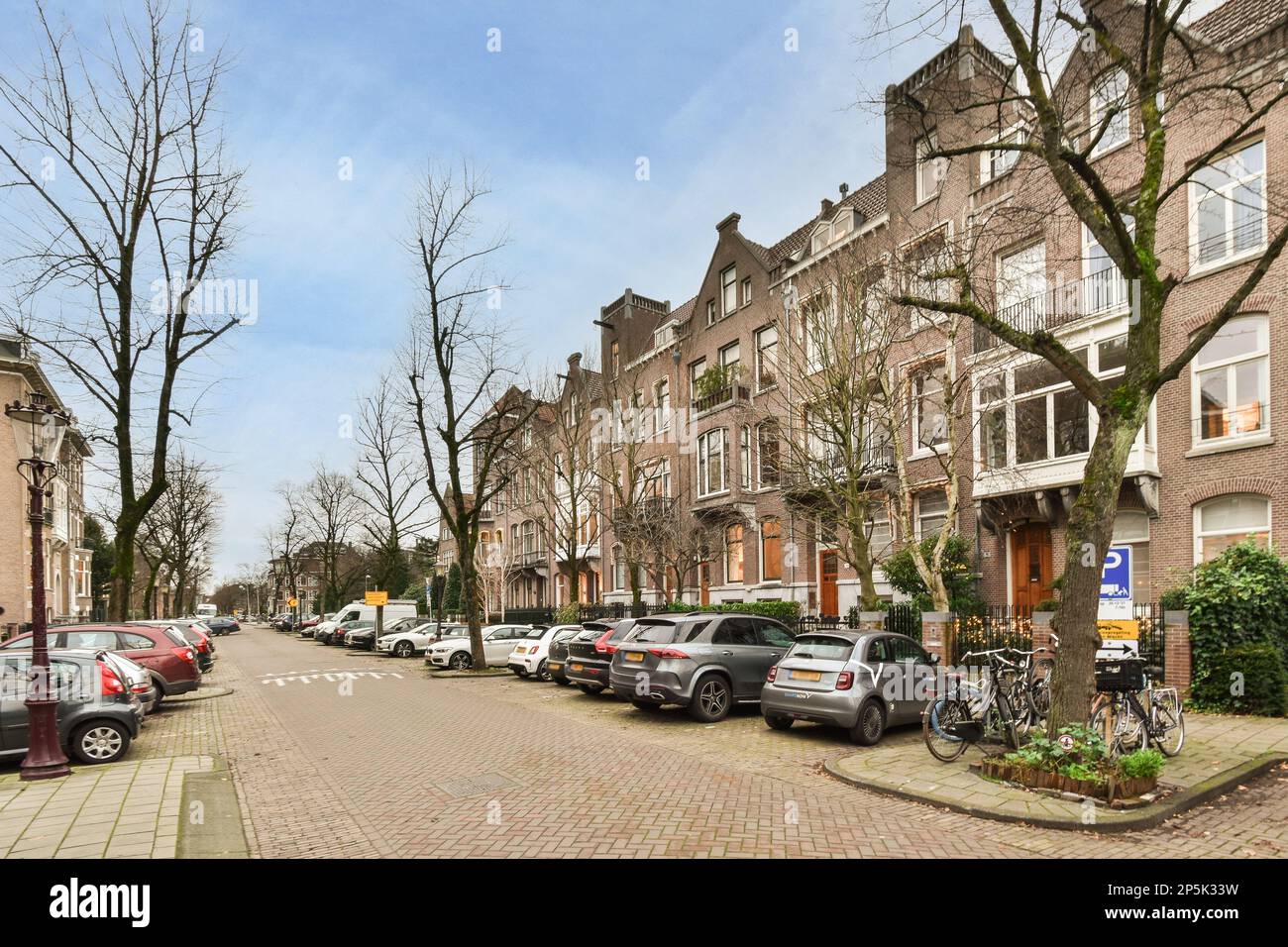 some cars parked on the side of a street in front of buildings and ...