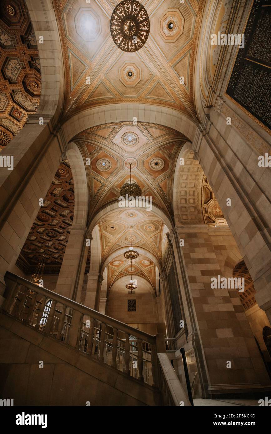 A vertical shot of the interior of an old building featuring a decorative ceiling Stock Photo